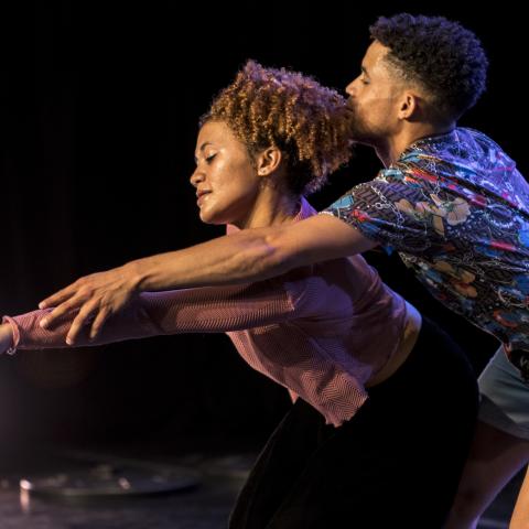 Garage Dance Ensemble by Ruth Smith Two dancers reach outwards towards a white light