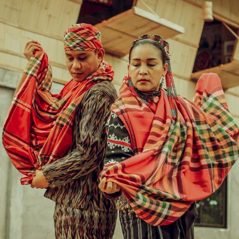 Helobung by Rmeo Muyco Espina Two people standing back to back, wearing traditional Filipino clothing